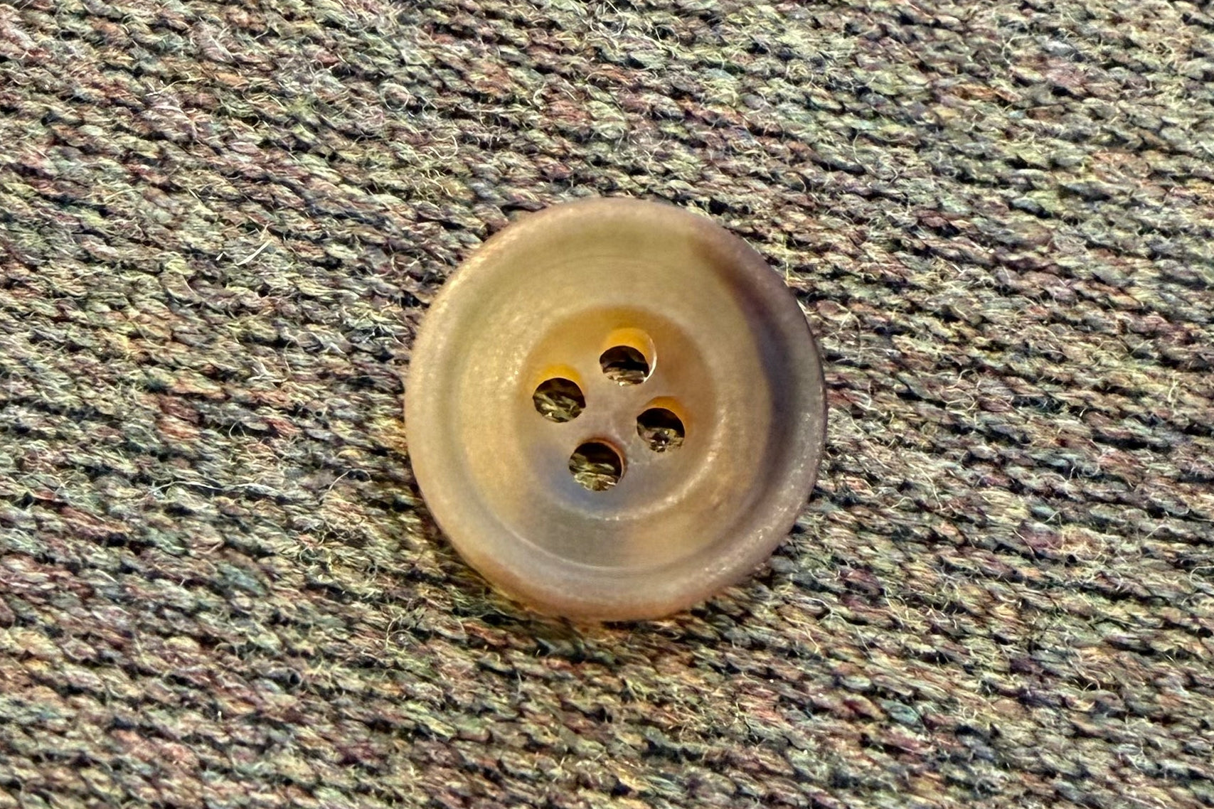 Close-up of a button on textured fabric