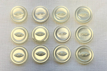 Set of white buttons on a textured surface
