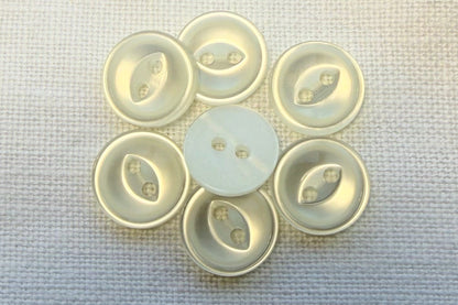 White buttons on a textured fabric background