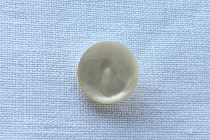 White button on a white fabric background